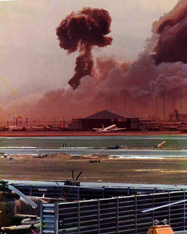 9. Da Nang AB: 366th TFW: From the bottow of the black column of smoke, you can see a rocket of something that cooked off blasting away like a roman-candle! April 27-1969. [Peter Halferty photo]. 