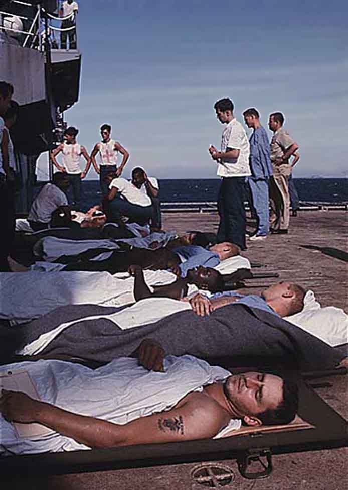 Da Nang Harbor. USS Repose, hospital ship docked. Wounded placed on deck awaiting bed space below.