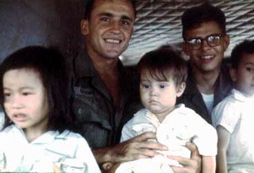 Wild Child II: Angel of Mercy, Huey Chopper. Crewman with Wounded Vietnamese Children. 1968.