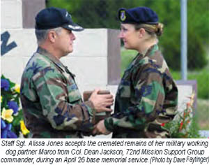 SSgt Alissa Jones accepts the cremated remains of her military working dog partner, Marco, from Col. Dean Jackson, 72nd Mission Support Group commander, during an April 26 [2007] base memorial serive. (Photo by: Dave Faytinger)